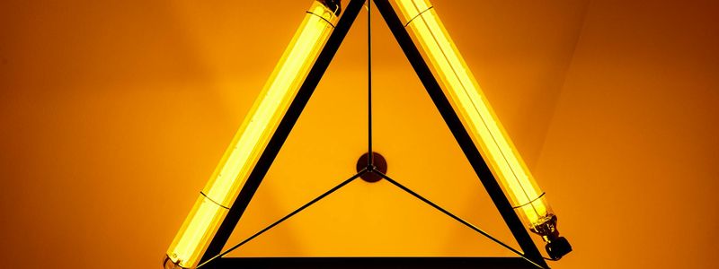 Abstract composition of geometric shapes in amber lighting