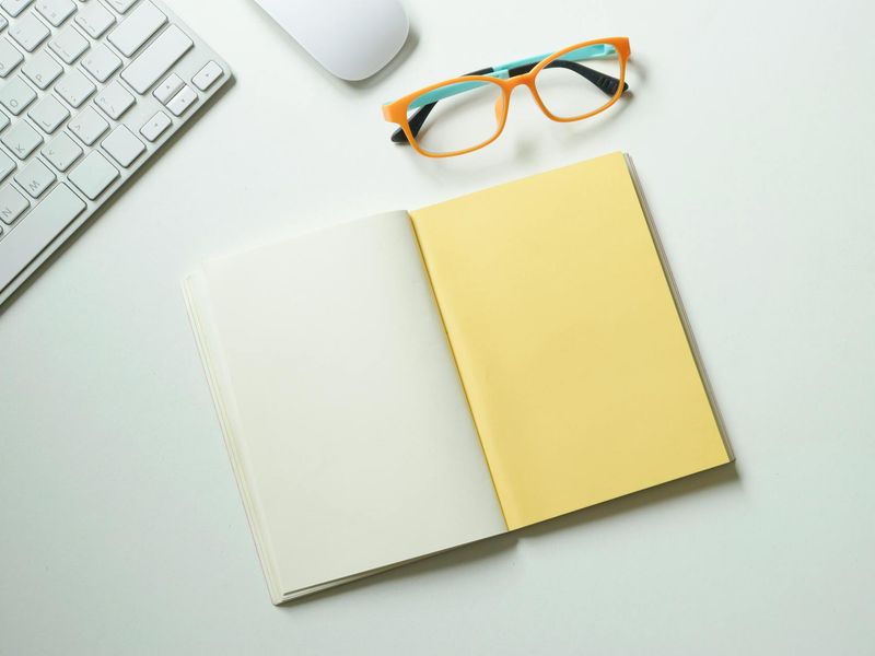 Clean workspace with a glass of water and notebook
