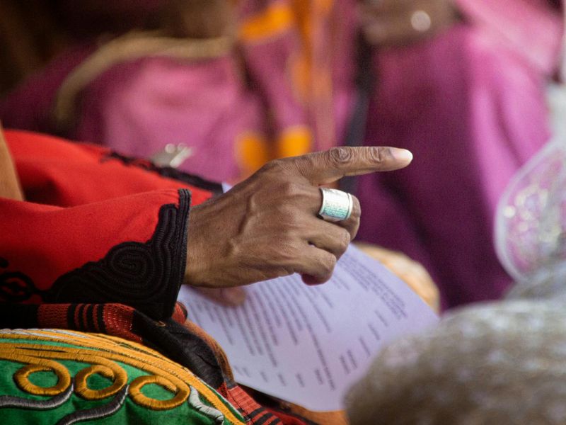 Detail of a person hand pointing to a distant point